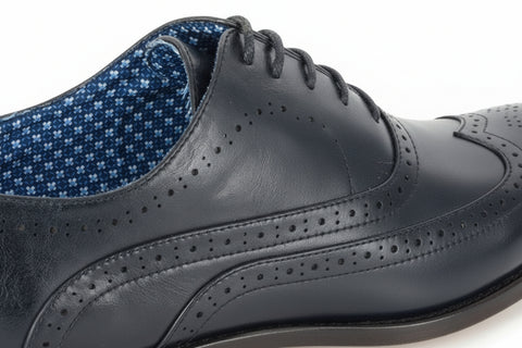 Close-up of a black leather shoe with blue lining on a white background UK Size 14