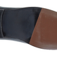 Close-up of a shoe sole with black and brown sections on a white UK Size 16 background
