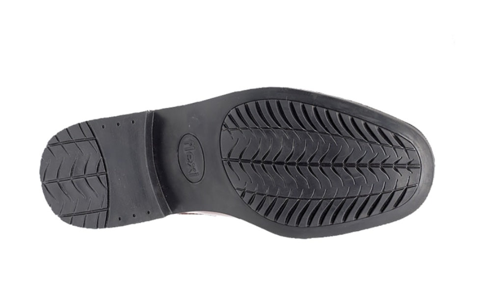 Black shoe sole with tread pattern on a white background UK Size 14