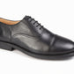 Black leather dress shoe on a white background UK Size 14